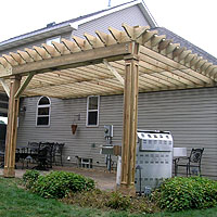 wood pergola with custom molding on the posts by elyria fence